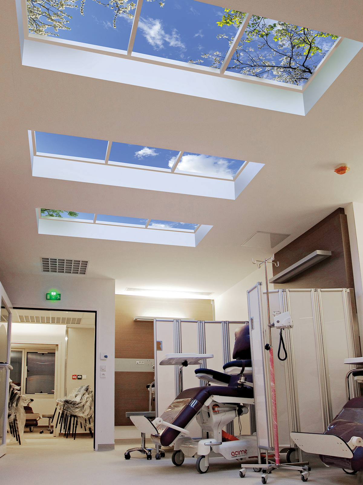 Individual patient bays for targeted chemotherapy treatments featuring Luminous SkyCeilings (sky ceilings) for patient wellness..